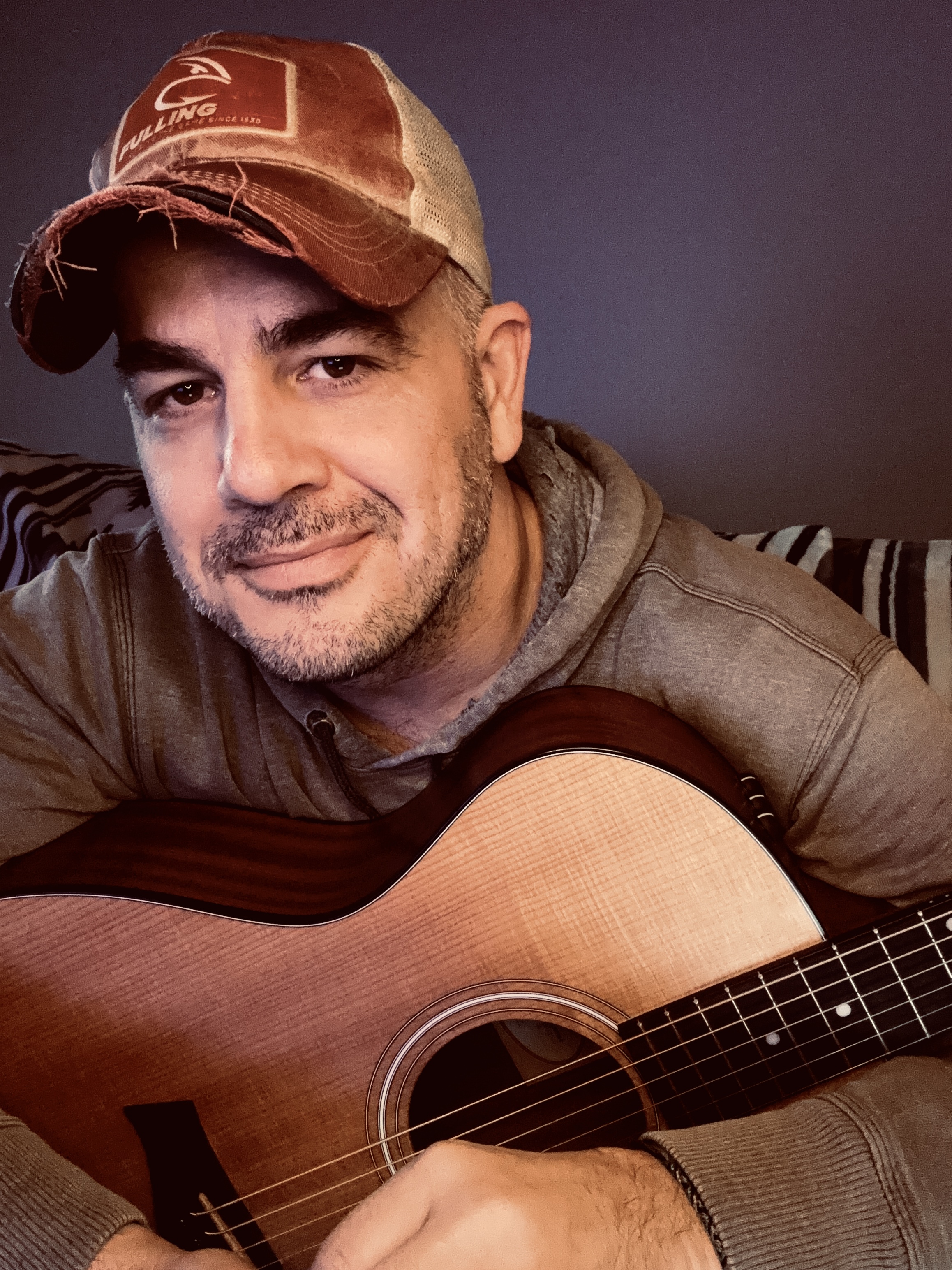 Terry Wayne holding an acoustic guitar